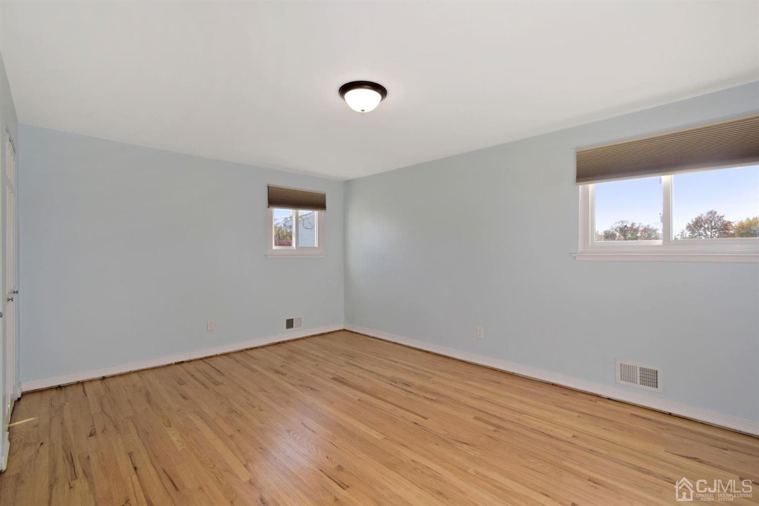 50 Gramercy Road Old Bridge, NJ 08857 - Photo 14 of 23 a view of an empty room with wooden floor and a window