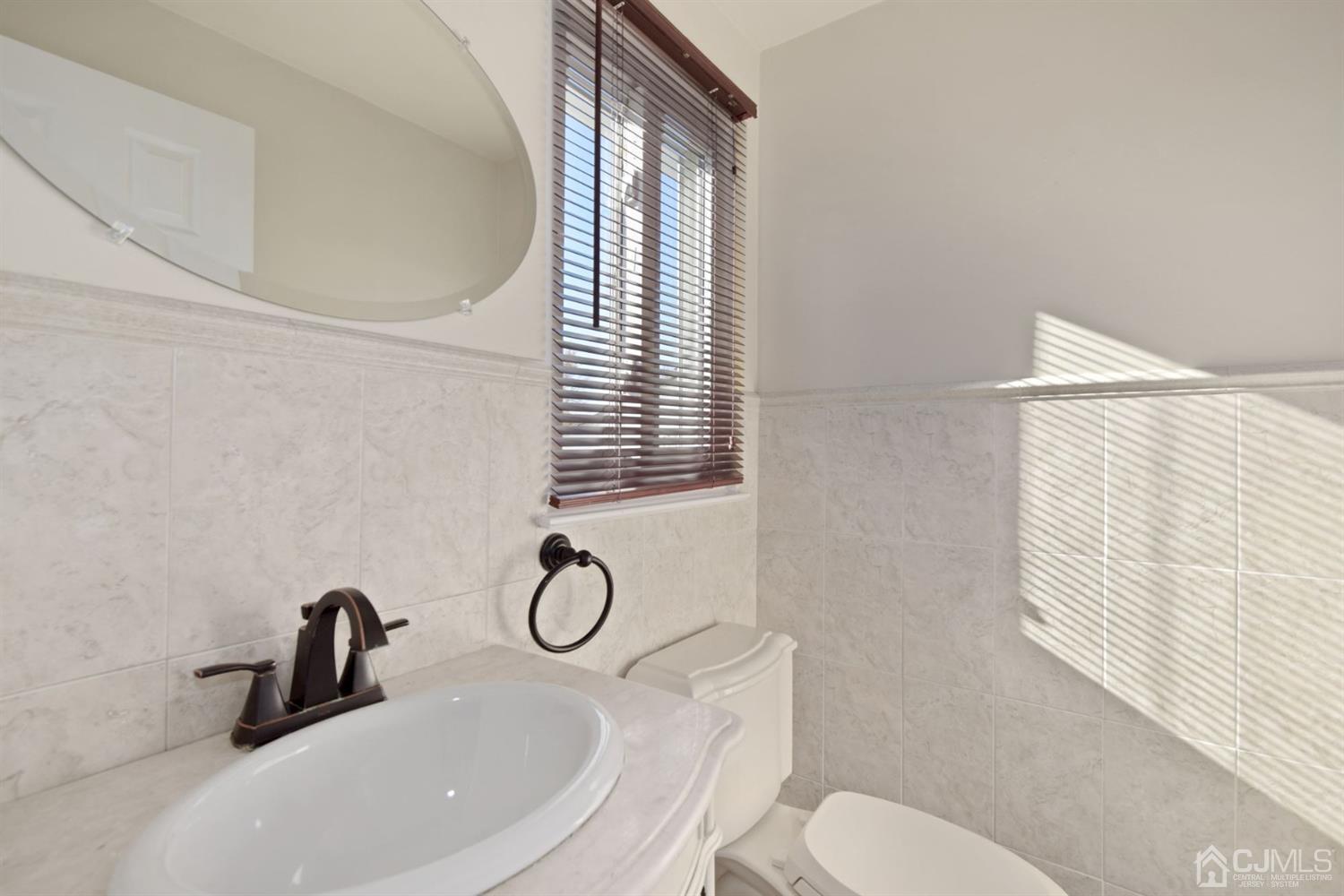 50 Gramercy Road Old Bridge, NJ 08857 - Photo 15 of 23 a bathroom with a sink mirror and toilet