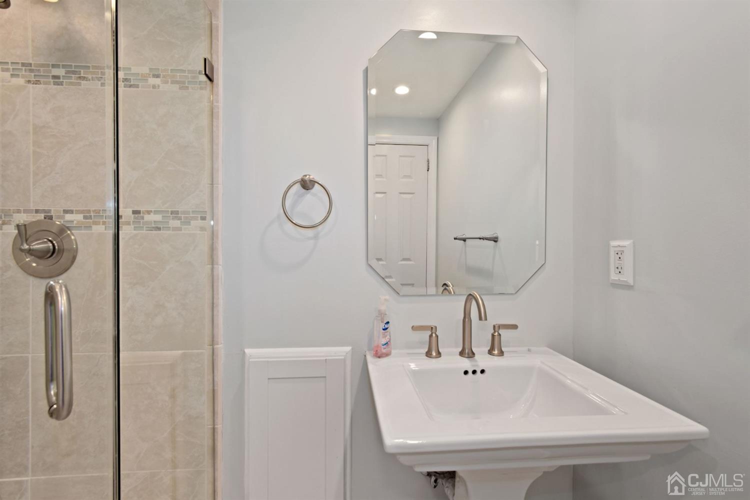 50 Gramercy Road Old Bridge, NJ 08857 - Photo 16 of 23 a bathroom with a sink a mirror and shower