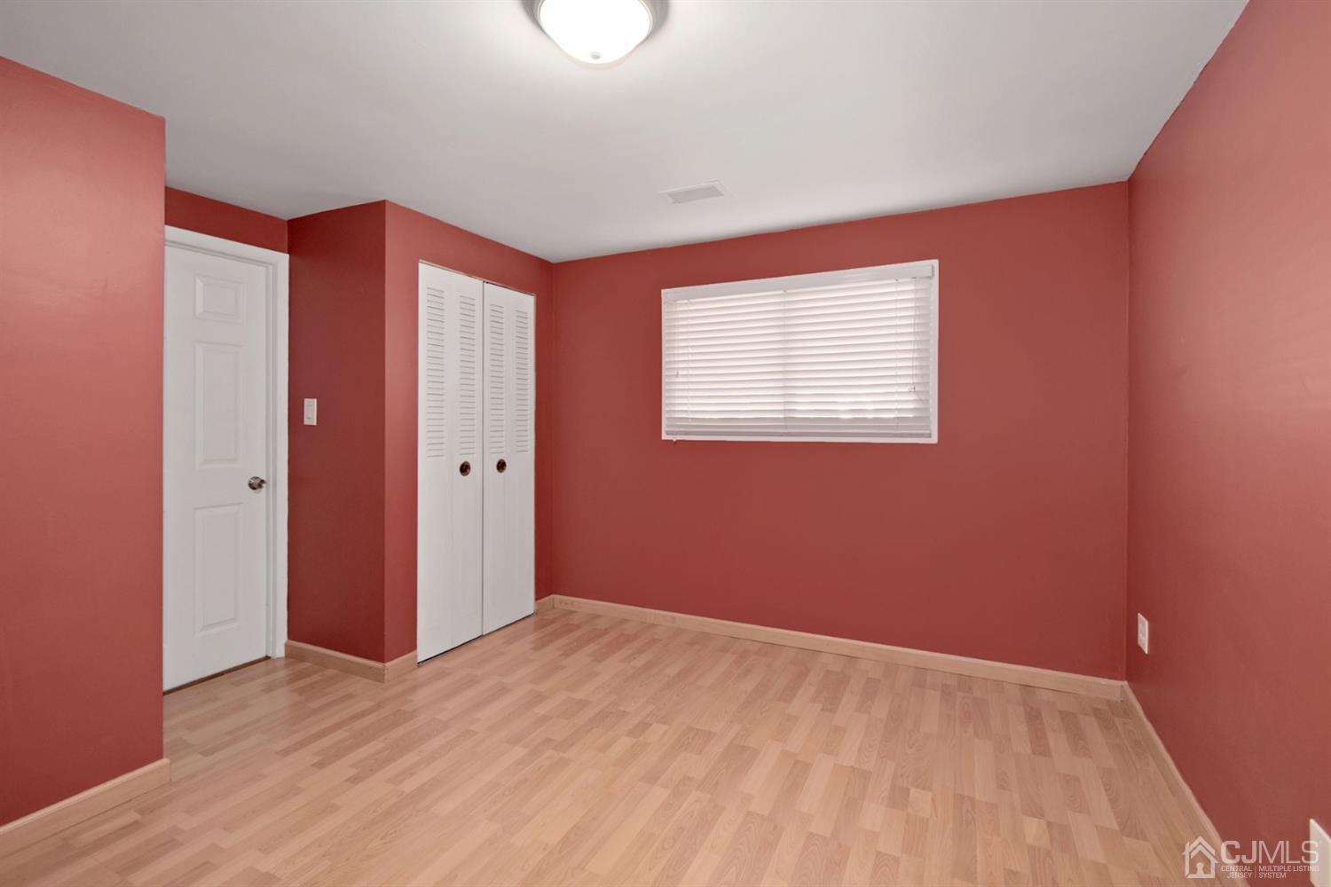 50 Gramercy Road Old Bridge, NJ 08857 - Photo 17 of 23 a view of an empty room with wooden floor and a window