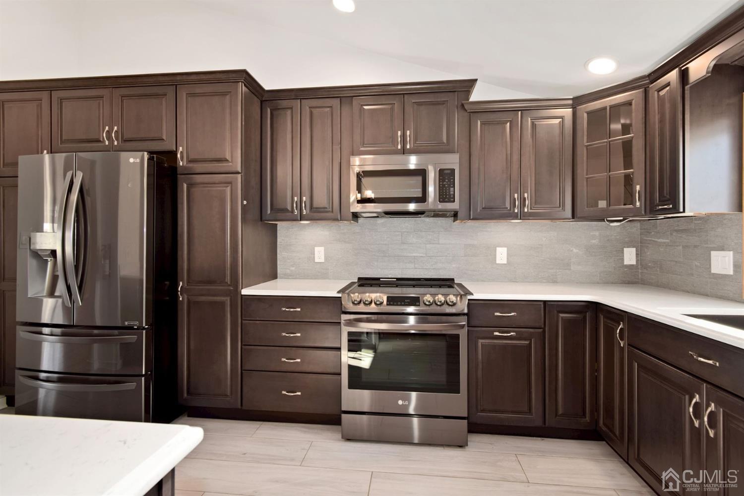 50 Gramercy Road Old Bridge, NJ 08857 - Photo 3 of 23 a kitchen with a sink stove and refrigerator