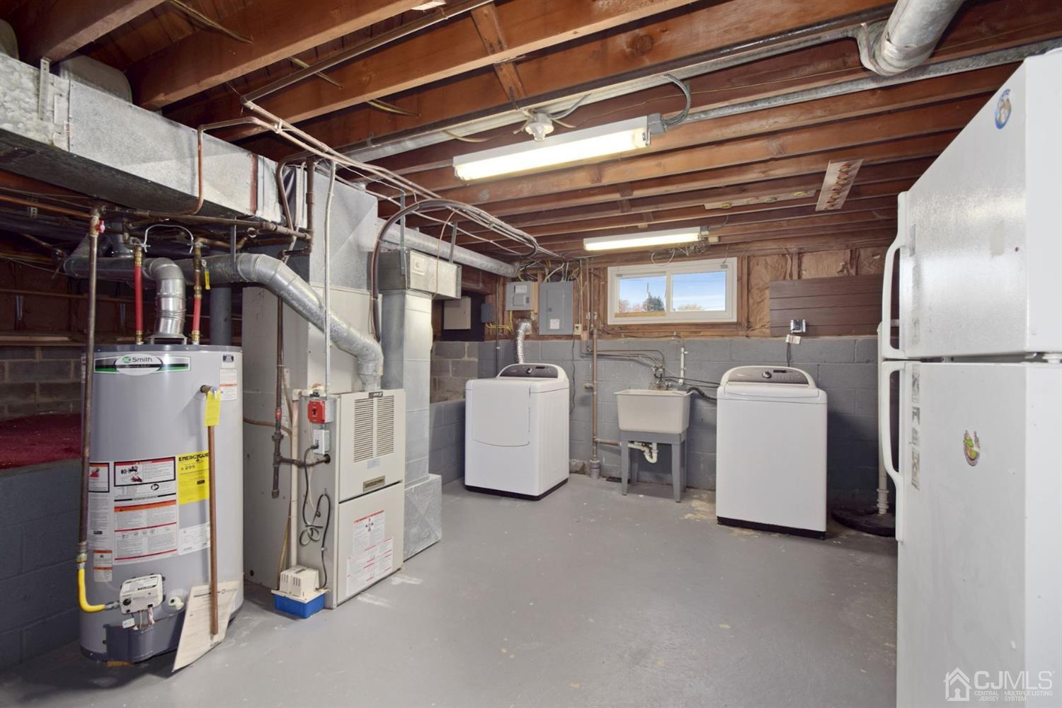 50 Gramercy Road Old Bridge, NJ 08857 - Photo 21 of 23 a view of storage and utility room with refrigerator and washer