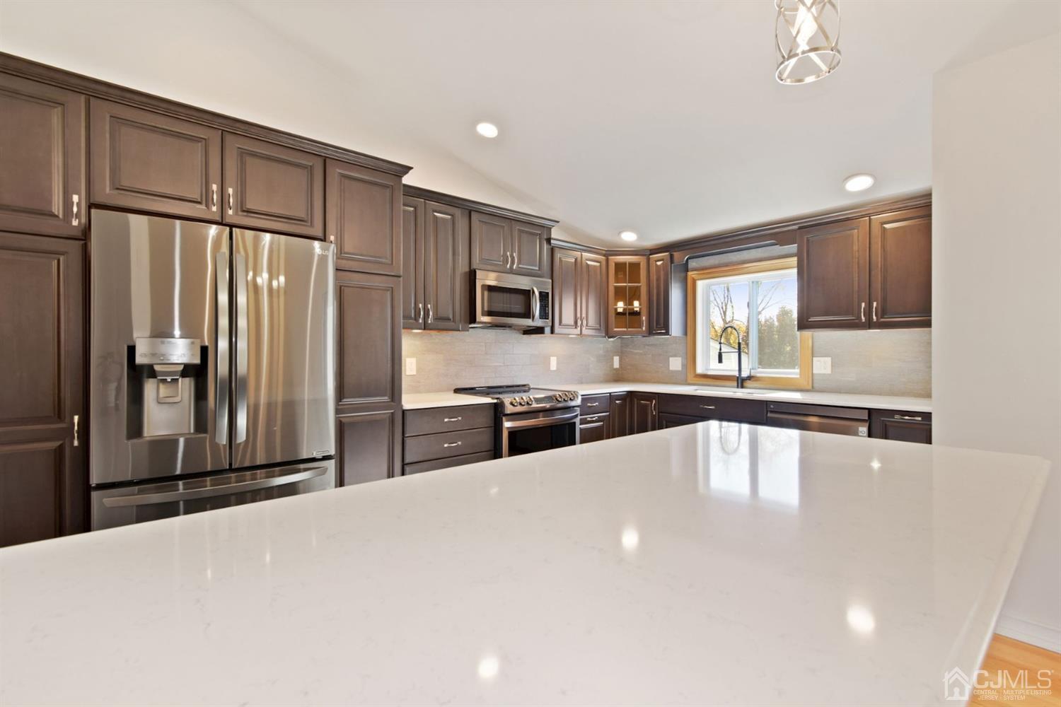 50 Gramercy Road Old Bridge, NJ 08857 - Photo 5 of 23 a large kitchen with stainless steel appliances a large counter top stainless steel appliances and cabinets