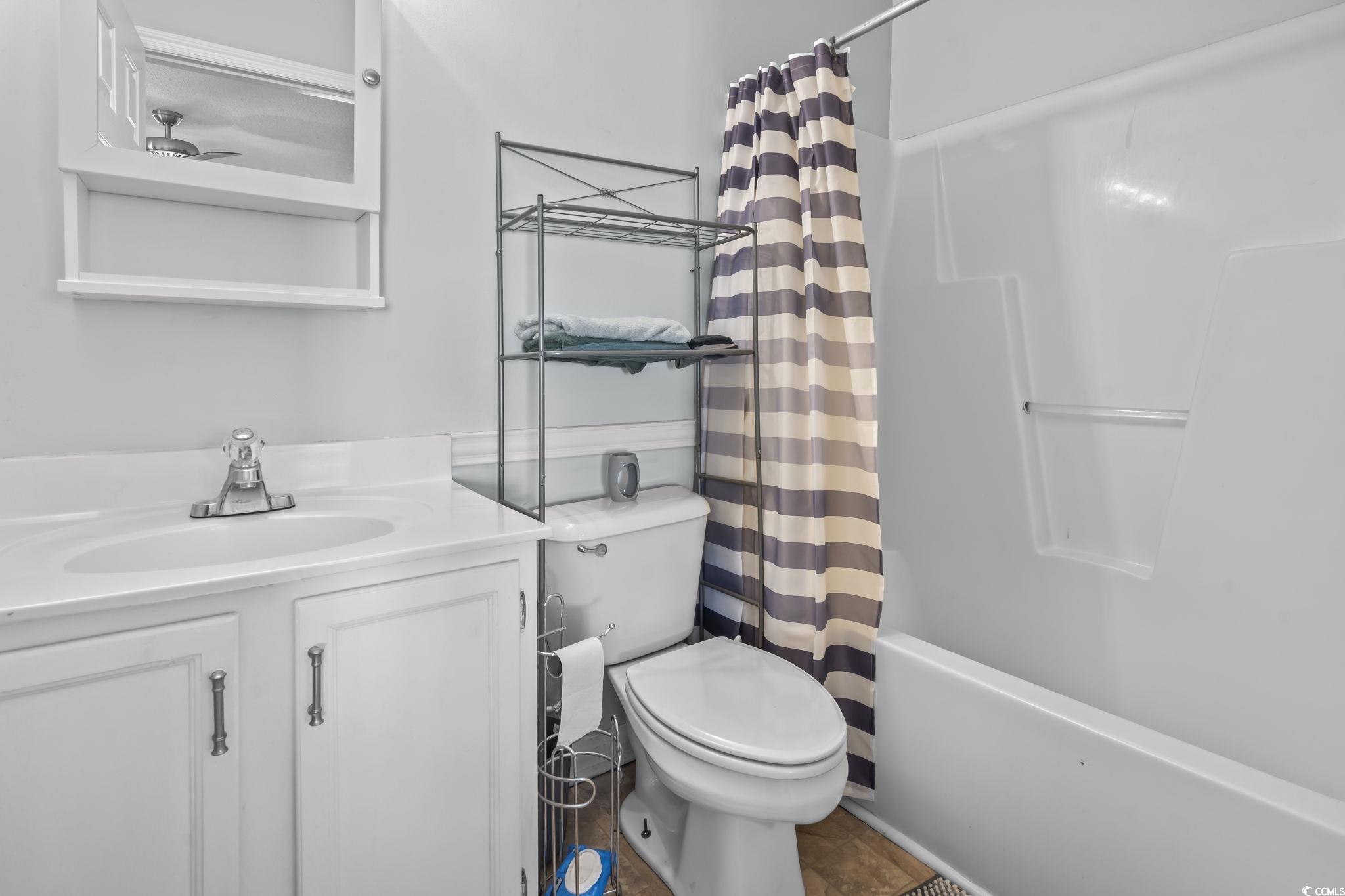 8010 Cone Court Murrells Inlet, SC 29576 - Photo 18 of 29 Full bath featuring vanity and shower / bath combo with shower curtain