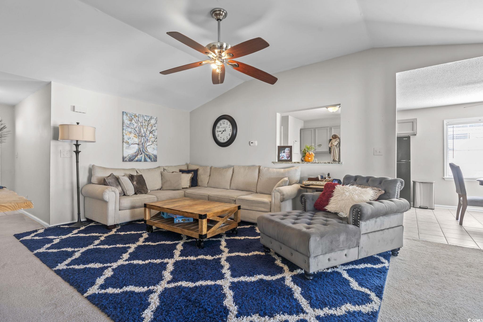 8010 Cone Court Murrells Inlet, SC 29576 - Photo 20 of 29 Carpeted living room with lofted ceiling and a ceiling fan