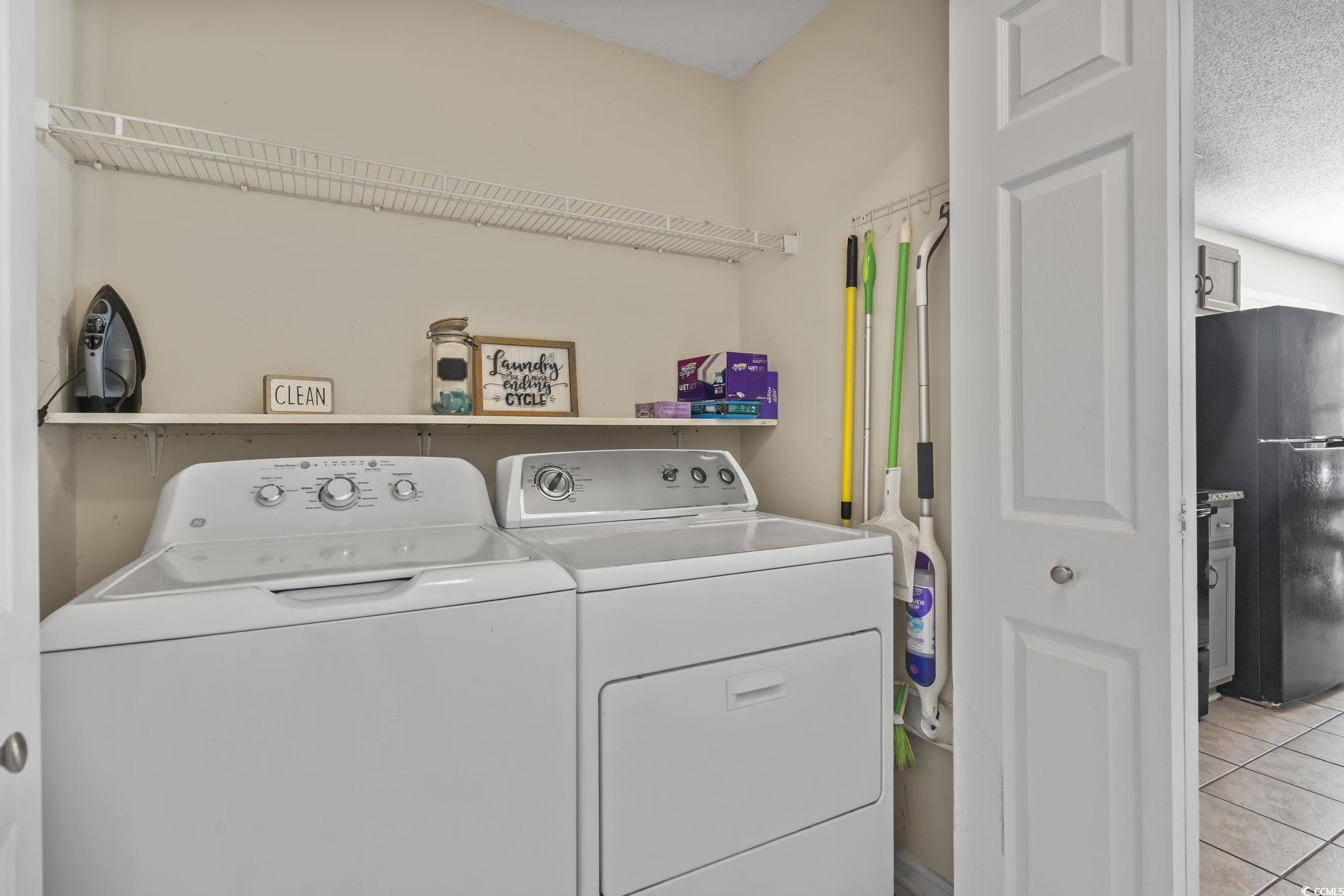 8010 Cone Court Murrells Inlet, SC 29576 - Photo 23 of 29 Washroom with a textured ceiling, light tile patterned floors, and washing machine and dryer