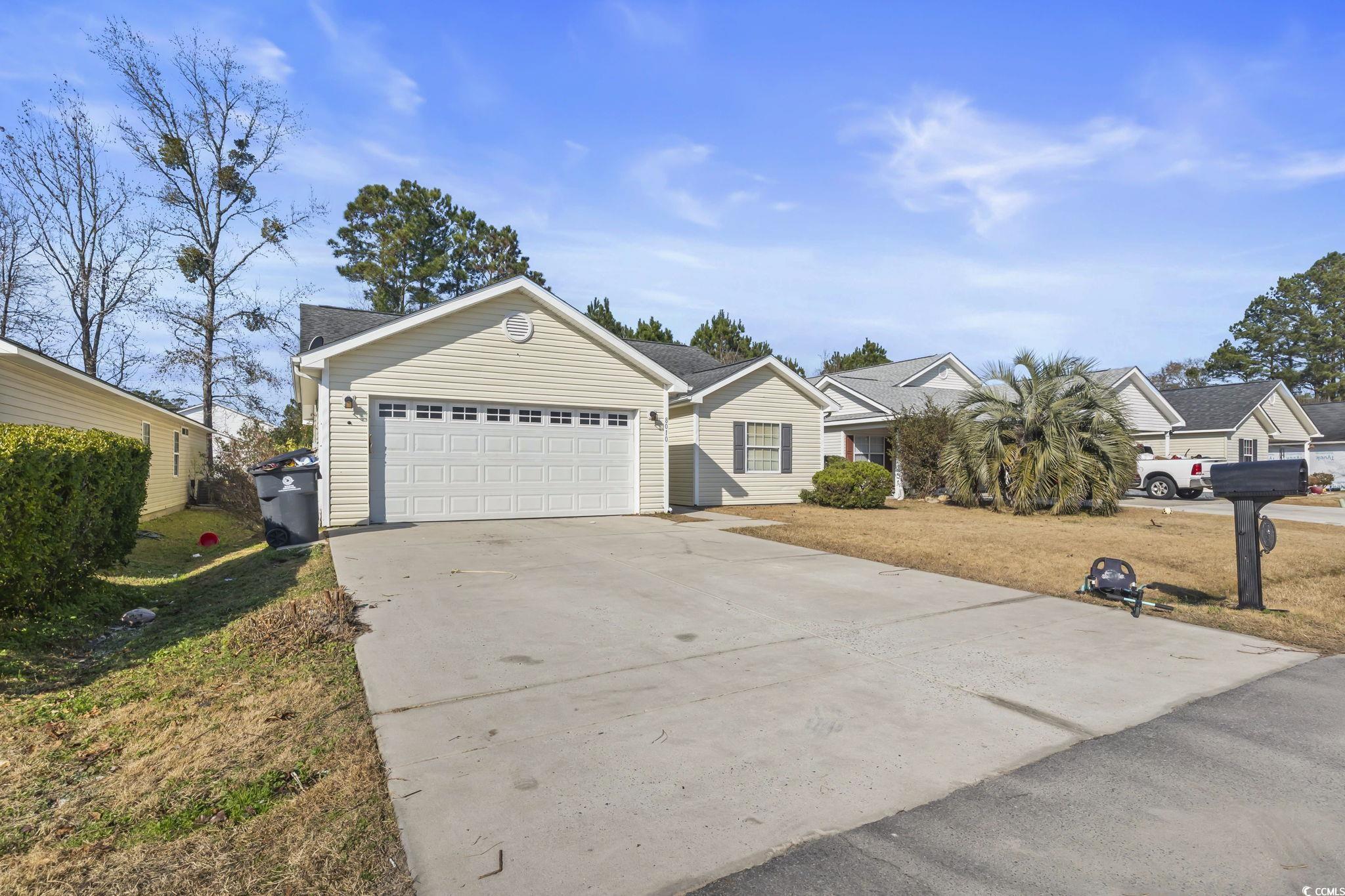 8010 Cone Court Murrells Inlet, SC 29576 - Photo 25 of 29 View of front of house with concrete driveway, a front lawn, and an attached garage