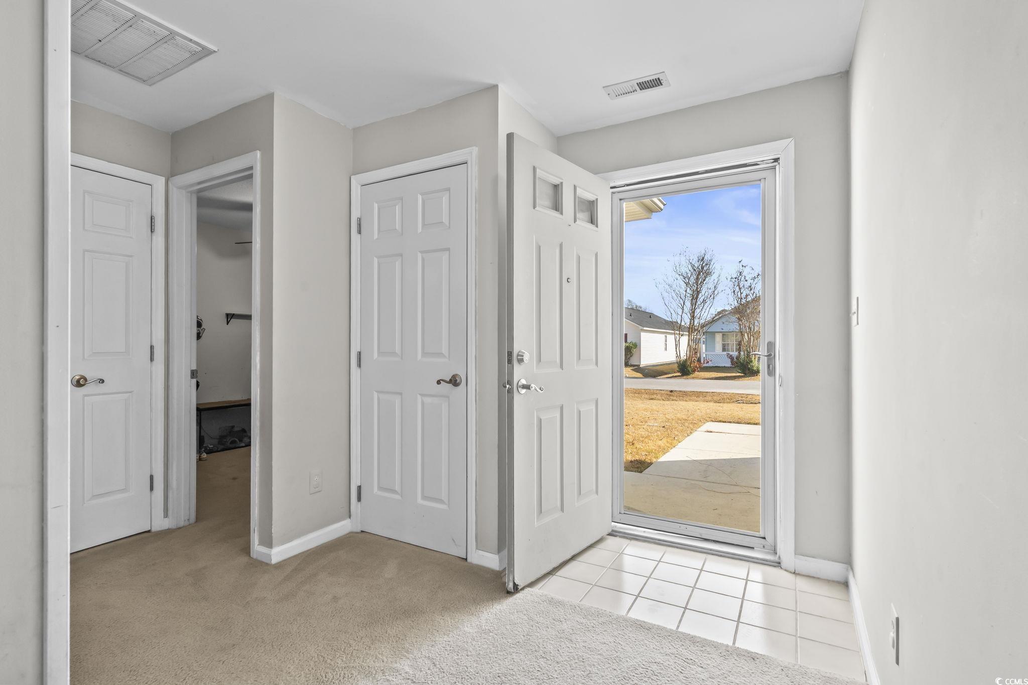 8010 Cone Court Murrells Inlet, SC 29576 - Photo 4 of 29 Foyer entrance featuring light carpet