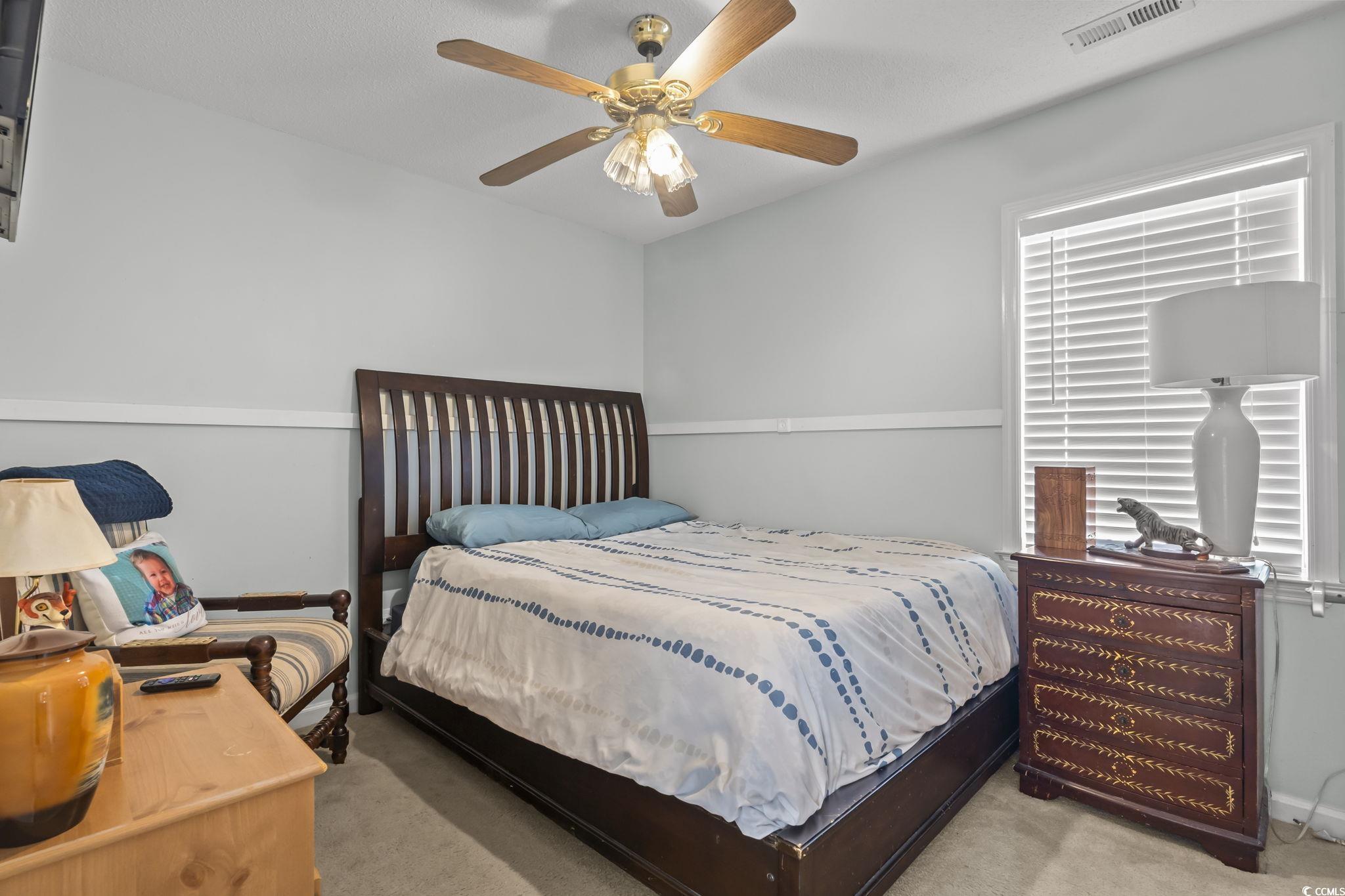 8010 Cone Court Murrells Inlet, SC 29576 - Photo 6 of 29 Bedroom with light colored carpet and ceiling fan