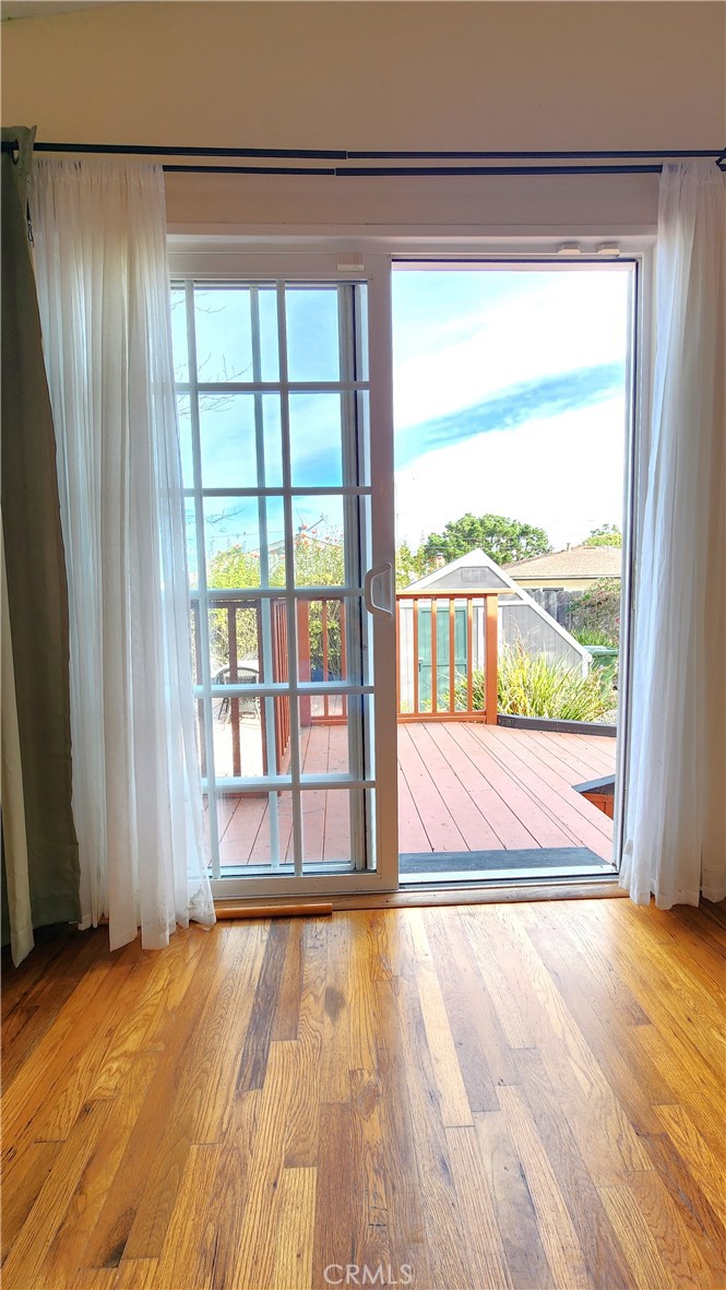 682 Taylor Street Monterey, CA 93940 - Photo 12 of 21 a view of an empty room with wooden floor and a window