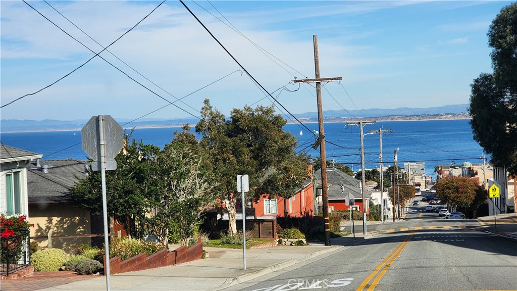 682 Taylor Street Monterey, CA 93940 - Photo 21 of 21 a street view with tall buildings and a yard