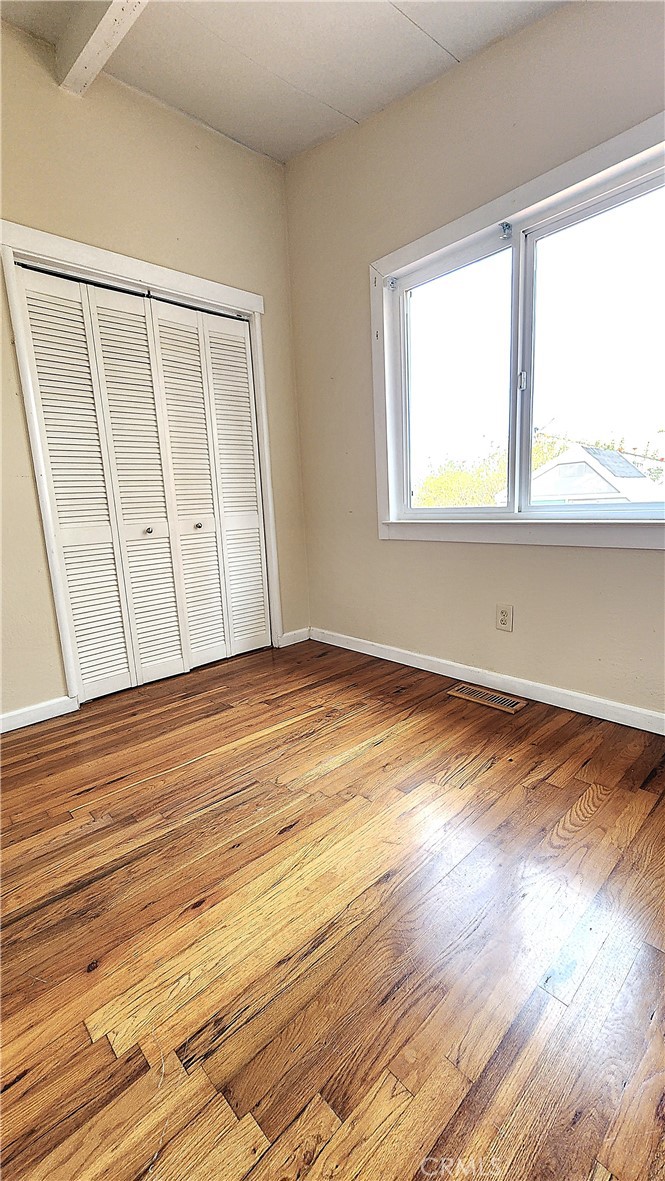 682 Taylor Street Monterey, CA 93940 - Photo 10 of 21 a view of an empty room with wooden floor and a window