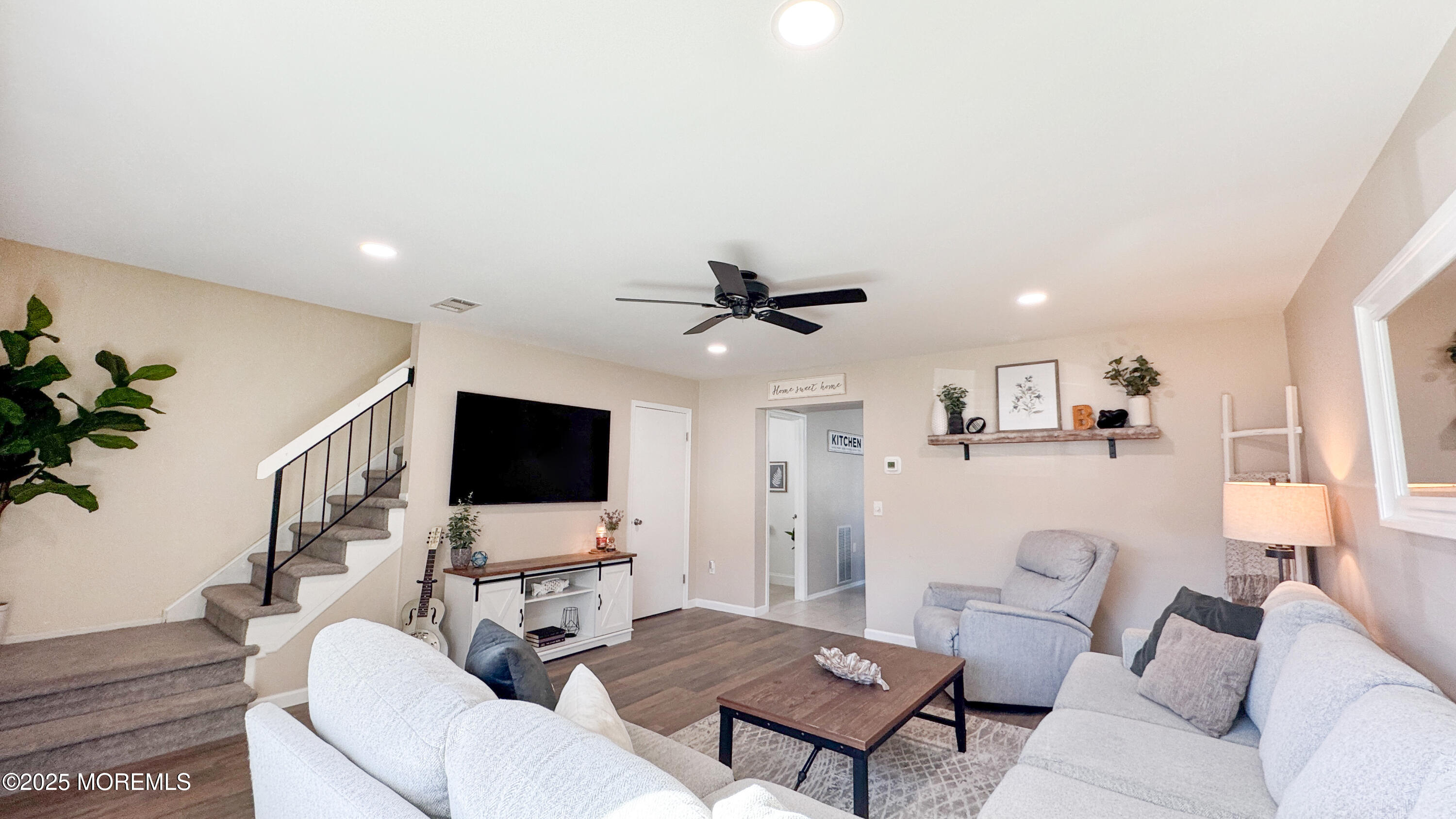 421 Sandra Place Brick, NJ 08724 - Photo 4 of 19 a living room with furniture a flat screen tv and a potted plant
