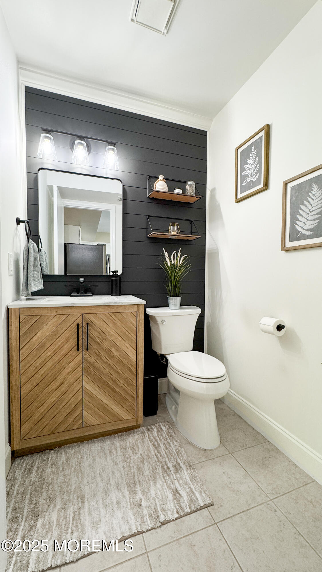 421 Sandra Place Brick, NJ 08724 - Photo 5 of 19 a bathroom with a toilet a sink and mirror
