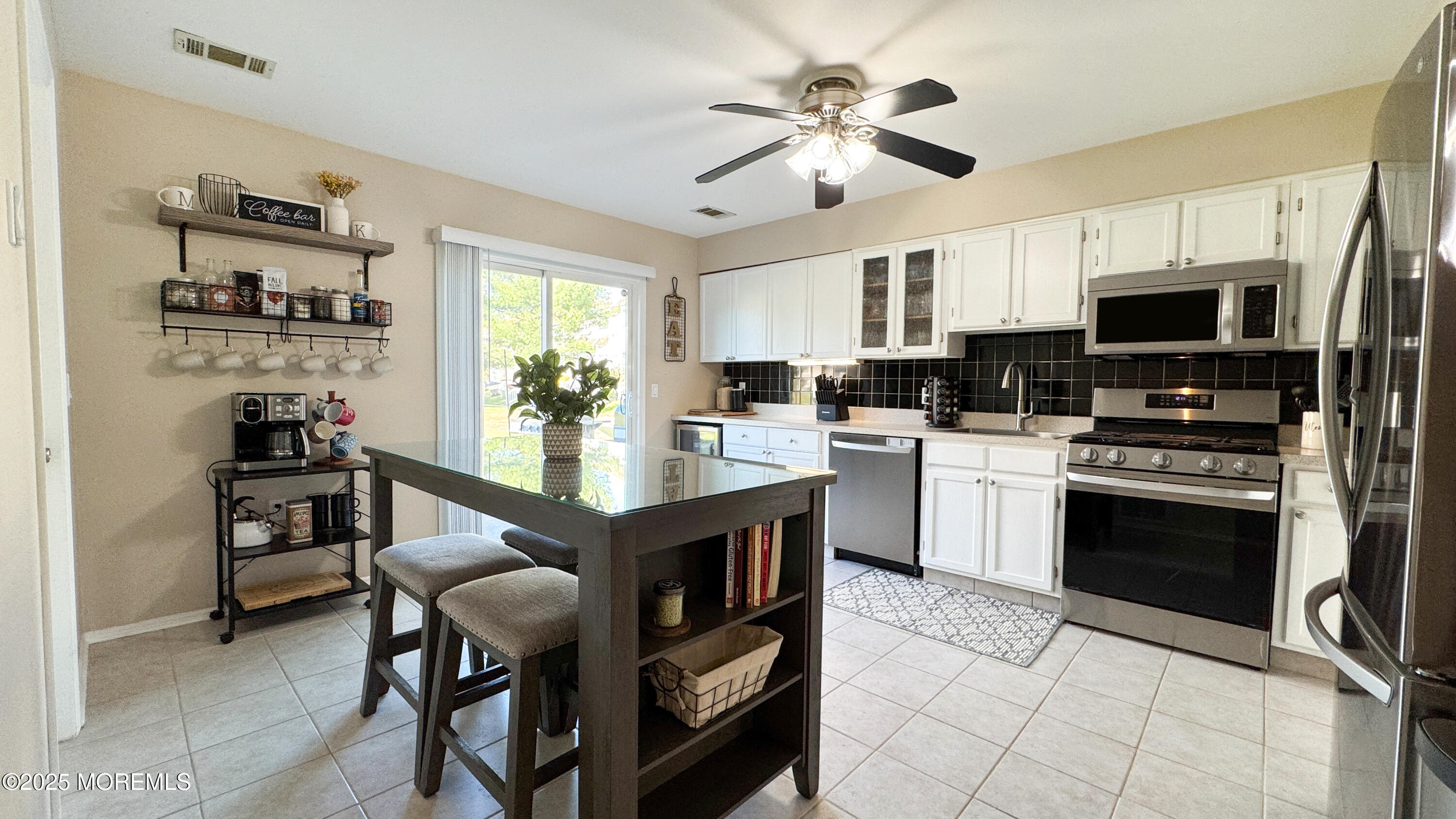 421 Sandra Place Brick, NJ 08724 - Photo 6 of 19 a kitchen with stainless steel appliances a stove sink microwave and cabinets