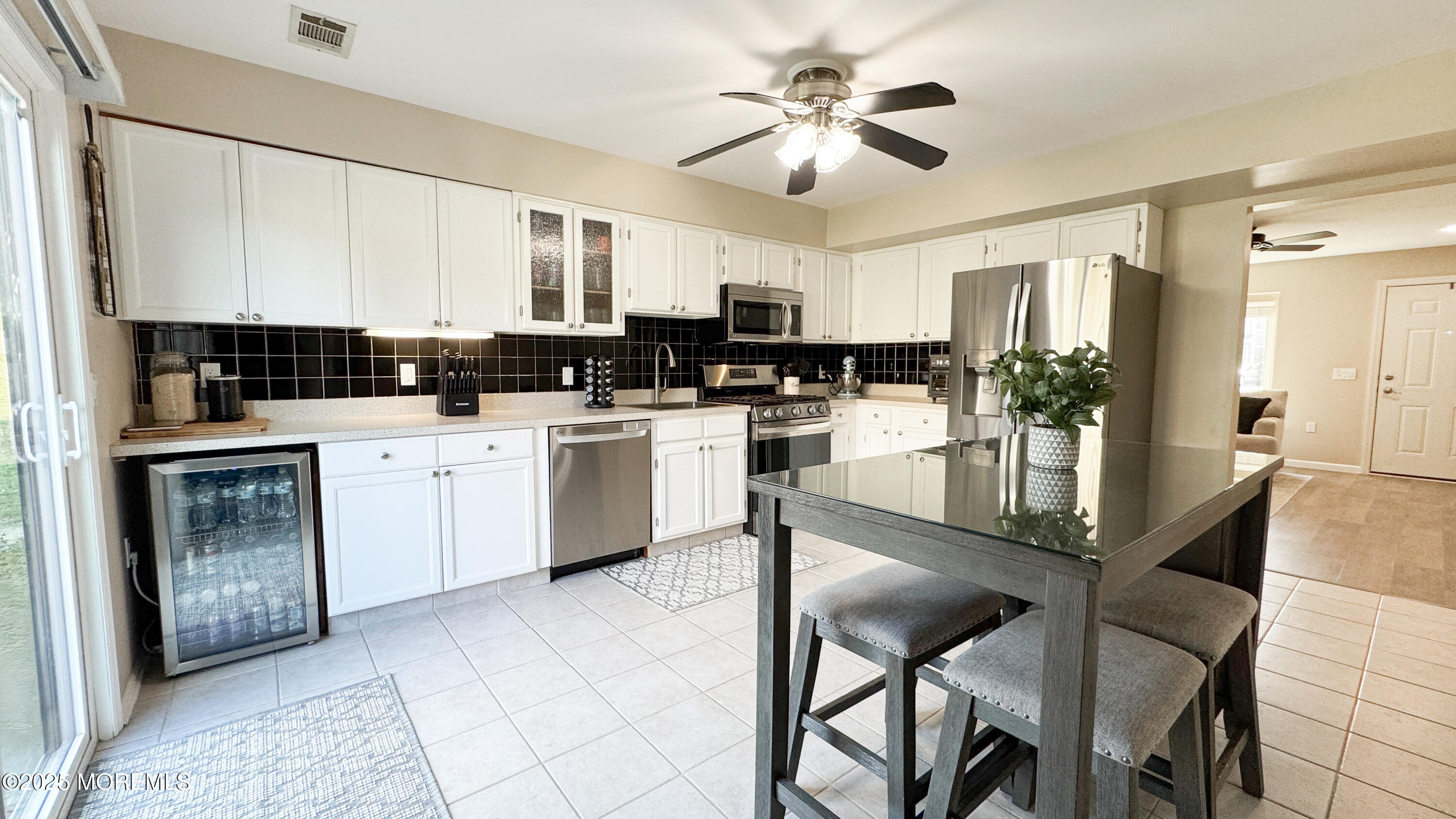 421 Sandra Place Brick, NJ 08724 - Photo 7 of 19 a kitchen with stainless steel appliances kitchen island granite countertop a stove refrigerator and cabinets