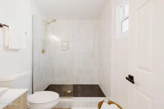 a white toilet sitting next to a shower curtain