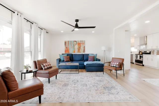 a living room with furniture and a large window