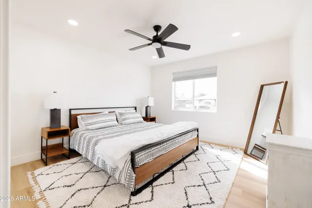 a bedroom with a bed and a window