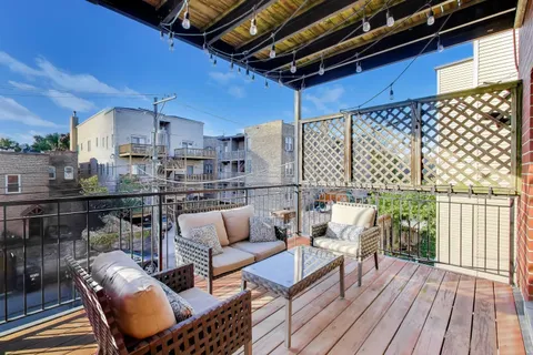 a balcony with furniture and wooden floor