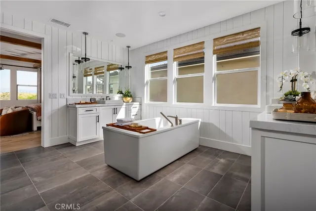 a living room with stainless steel appliances a stove a sink and a refrigerator