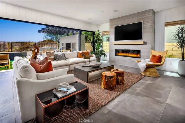 a living room with furniture a flat screen tv and a fireplace