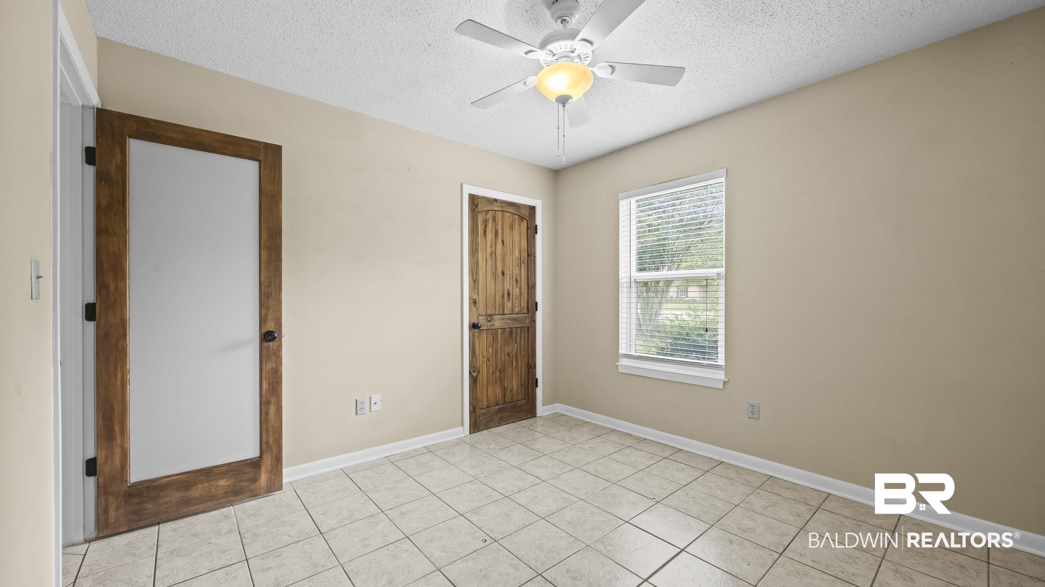 15096 Highland Circle Foley, AL 36535 - Photo 24 of 52 Neutral-toned interior room featuring light-colored tile flooring, a window with horizontal blinds, and a ceiling fan with integrated lighting