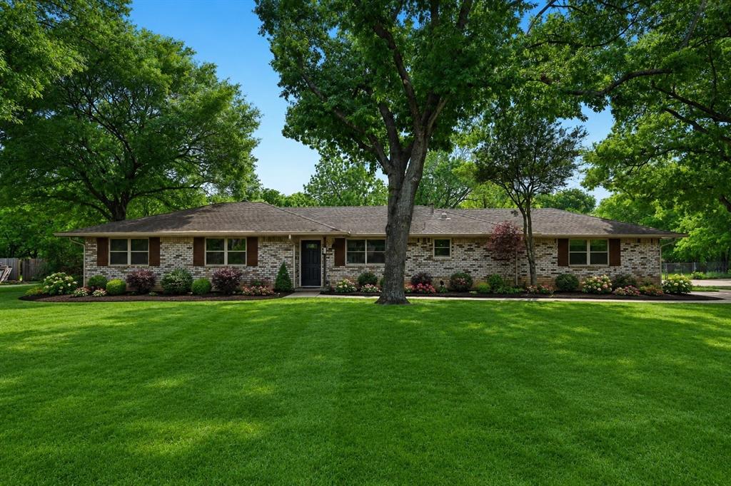 305 South Cockrell Hill Road Ovilla, TX 75154 - Photo 1 of 40 a front view of a house with a garden