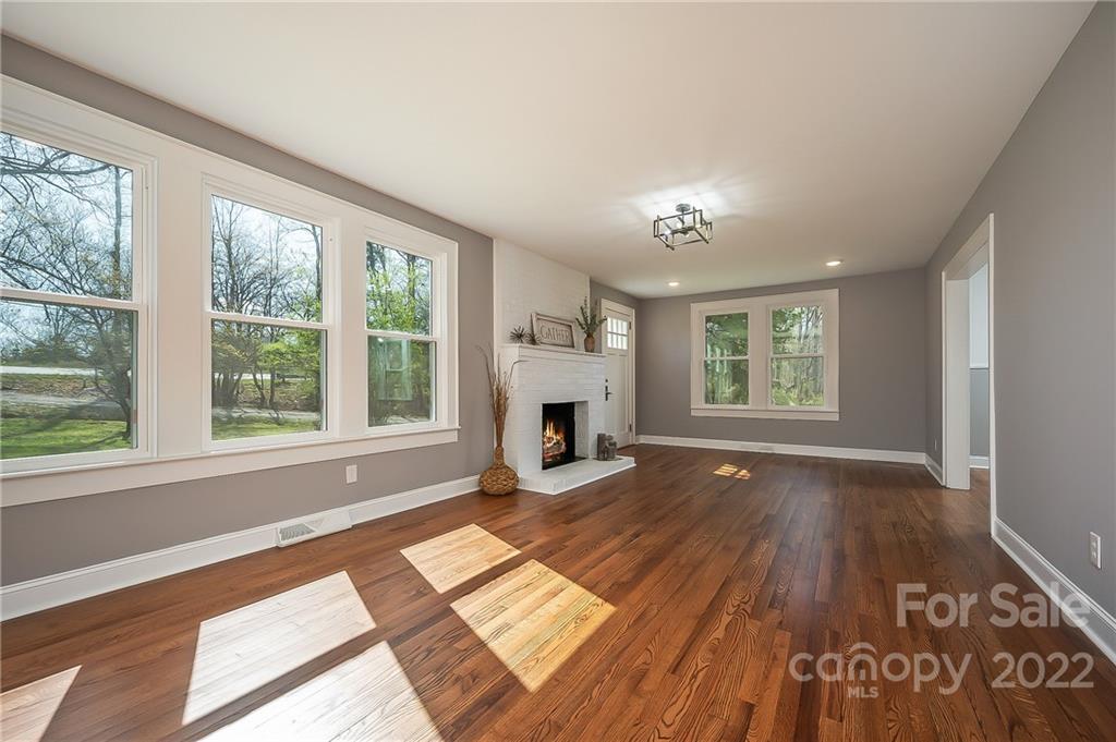 1141 Highway 64 Rutherfordton, NC 28139 - Photo 11 of 37 wooden floor fireplace and windows in an empty room