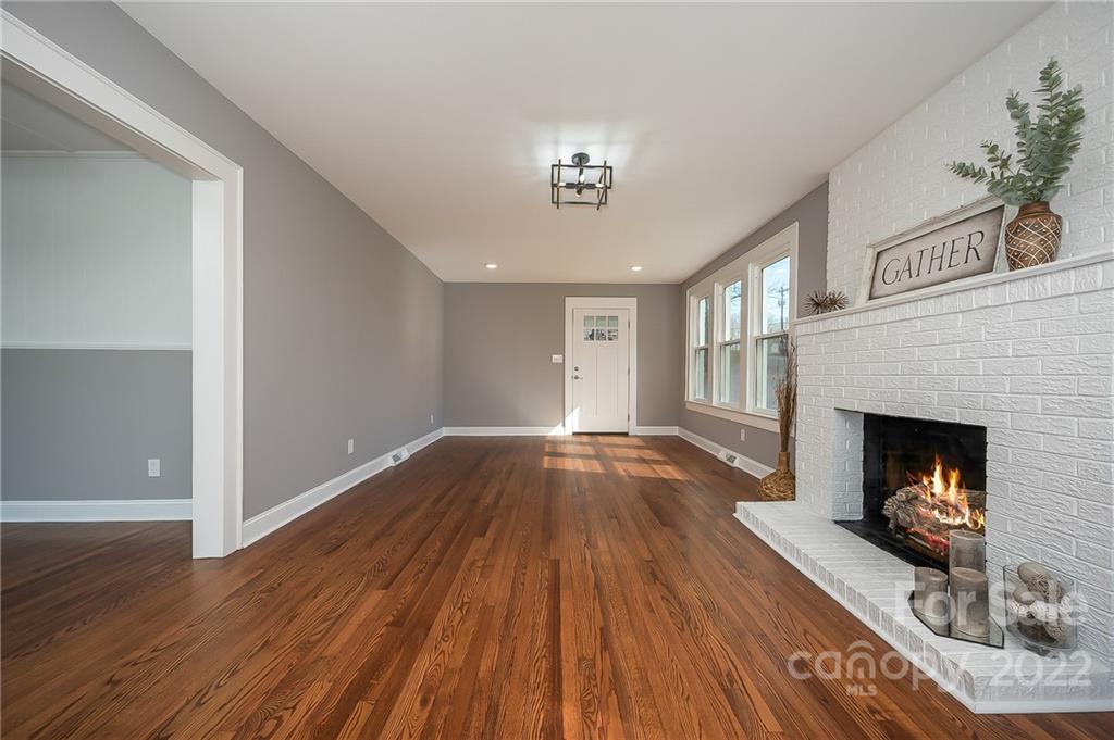1141 Highway 64 Rutherfordton, NC 28139 - Photo 13 of 37 a view of an empty room with wooden floor fireplace and a window