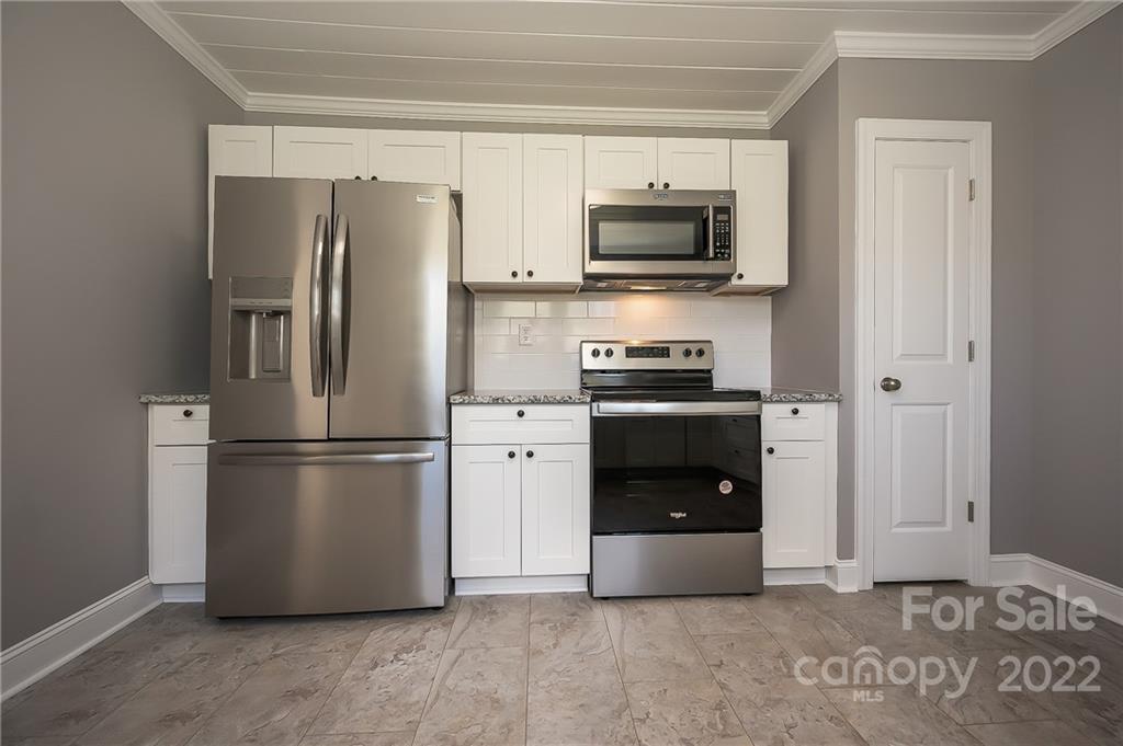 1141 Highway 64 Rutherfordton, NC 28139 - Photo 19 of 37 a kitchen with stainless steel appliances a refrigerator and a stove top oven