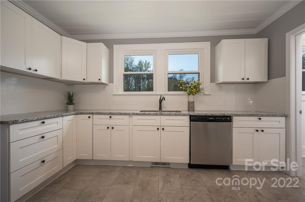 1141 Highway 64 Rutherfordton, NC 28139 - Photo 21 of 37 a kitchen with granite countertop white cabinets white stainless steel appliances with a sink and dishwasher