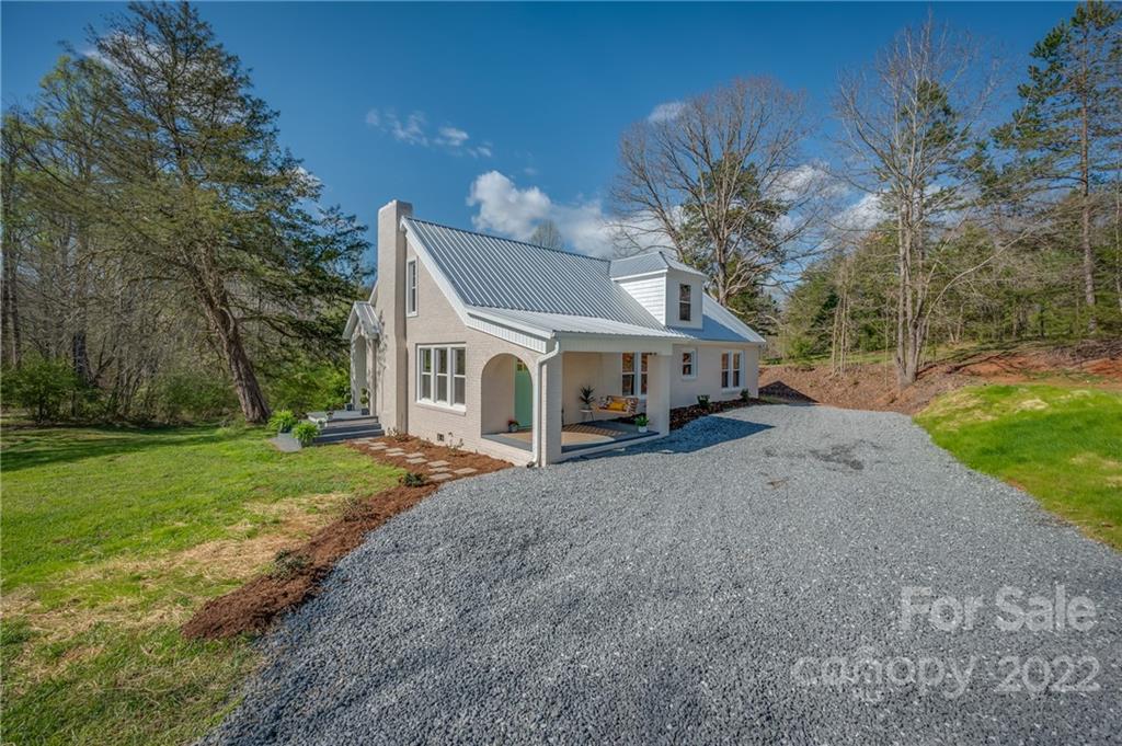 1141 Highway 64 Rutherfordton, NC 28139 - Photo 7 of 37 a front view of a house with a yard and garage