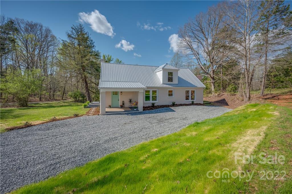 1141 Highway 64 Rutherfordton, NC 28139 - Photo 8 of 37 a view of a house with a yard and potted plants