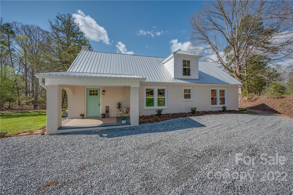 1141 Highway 64 Rutherfordton, NC 28139 - Photo 9 of 37 a front view of a house with garden