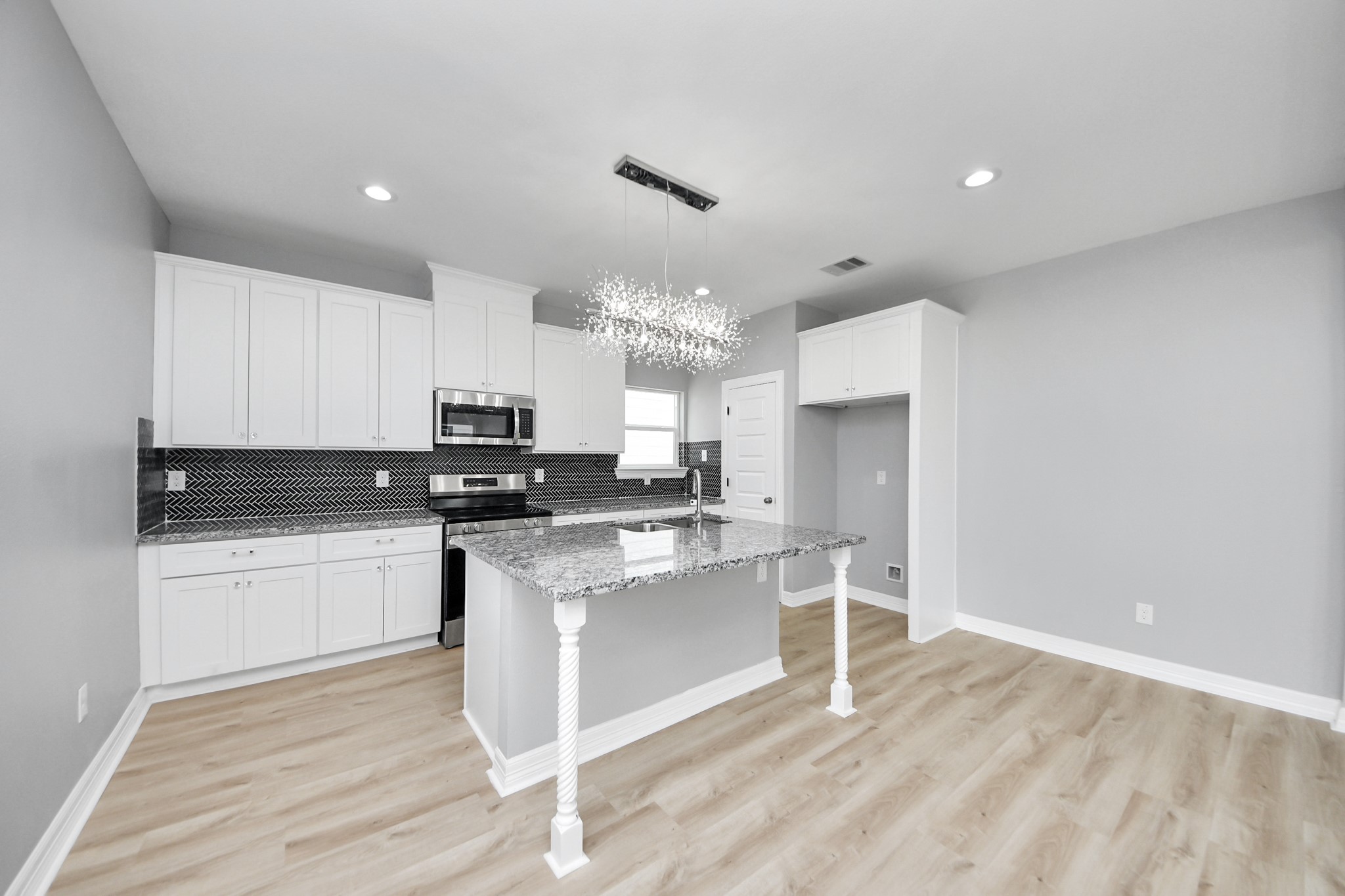 406 North 4th Street Beasley, TX 77417 - Photo 8 of 29 a kitchen with stainless steel appliances granite countertop a stove a sink and a refrigerator