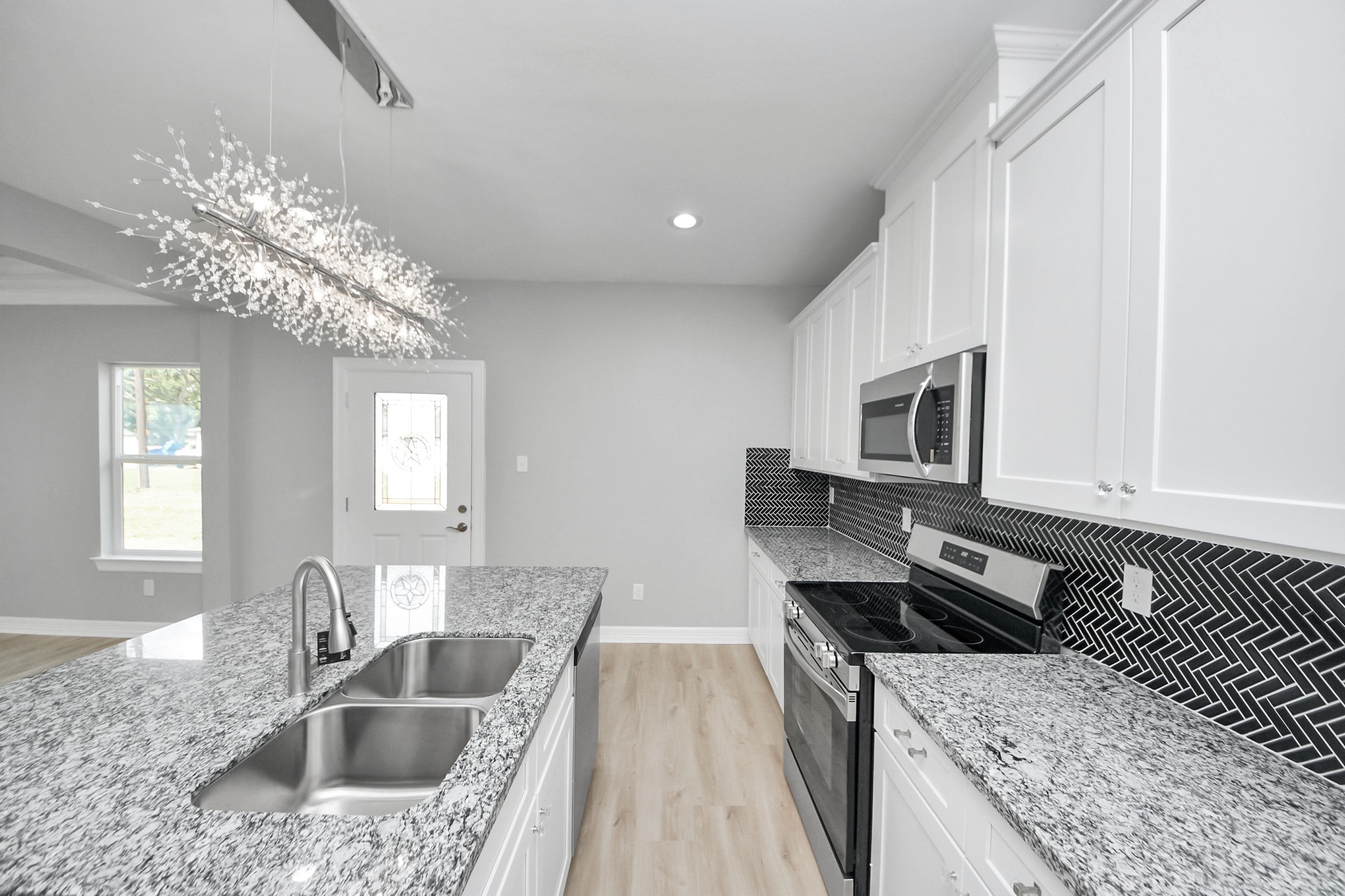 406 North 4th Street Beasley, TX 77417 - Photo 10 of 29 a kitchen with stainless steel appliances granite countertop a sink stove and refrigerator