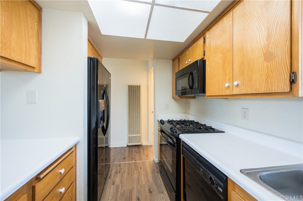 2010 Robles Perdido Drive, Unit A Los Osos, CA 93402 - Photo 11 of 28 a kitchen with stainless steel appliances granite countertop a sink and a stove