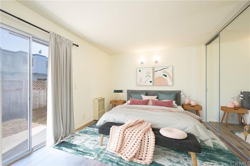 2010 Robles Perdido Drive, Unit A Los Osos, CA 93402 - Photo 17 of 28 a bedroom with a bed and glass door