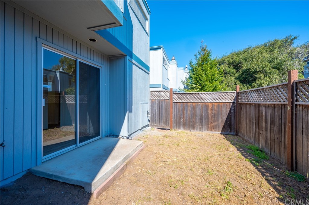 2010 Robles Perdido Drive, Unit A Los Osos, CA 93402 - Photo 21 of 28 a view of backyard with wooden fence and large trees