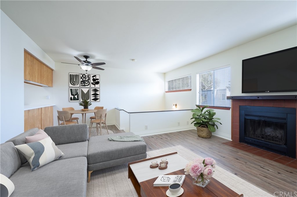 2010 Robles Perdido Drive, Unit A Los Osos, CA 93402 - Photo 7 of 28 a living room with furniture a fireplace and a flat screen tv