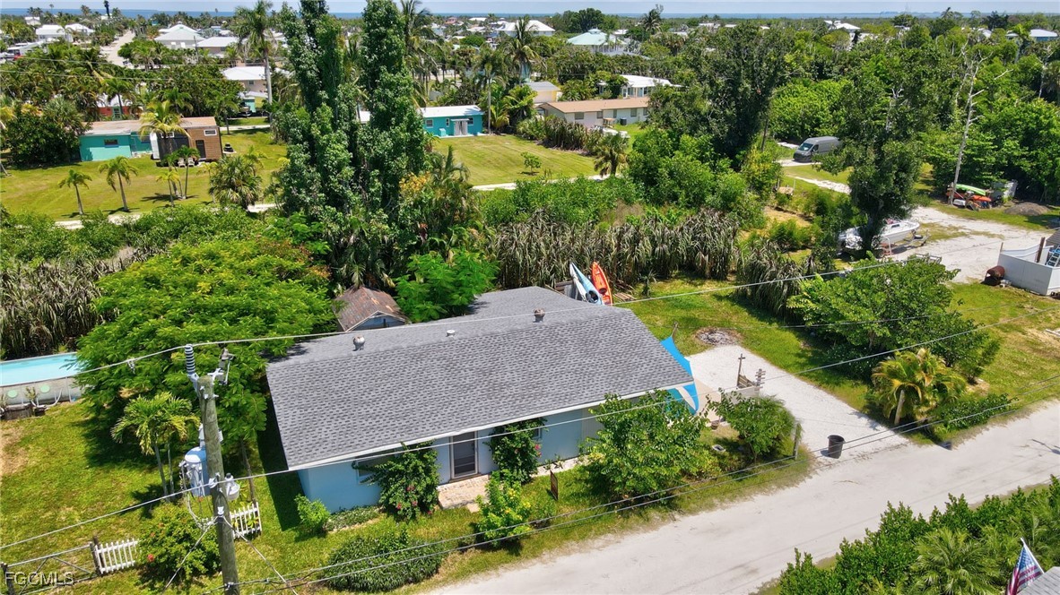 7462 Pentz Road Bokeelia, FL 33922 - Photo 20 of 22 an aerial view of a house with a yard and large trees