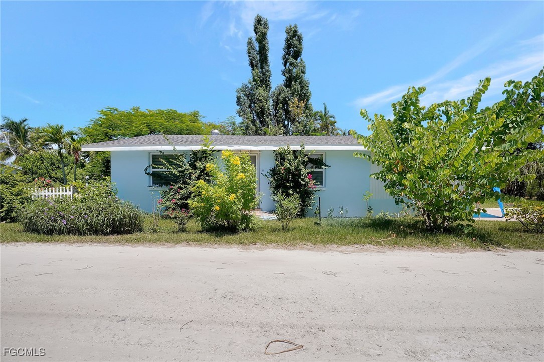 7462 Pentz Road Bokeelia, FL 33922 - Photo 3 of 22 a front view of a house with garden