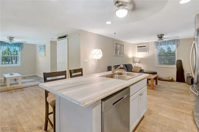 a view of kitchen island a sink table and chairs