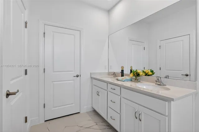 a bathroom with a shower sink and mirror