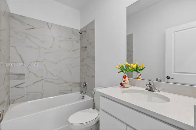 a view of an empty room with closet and wooden floor