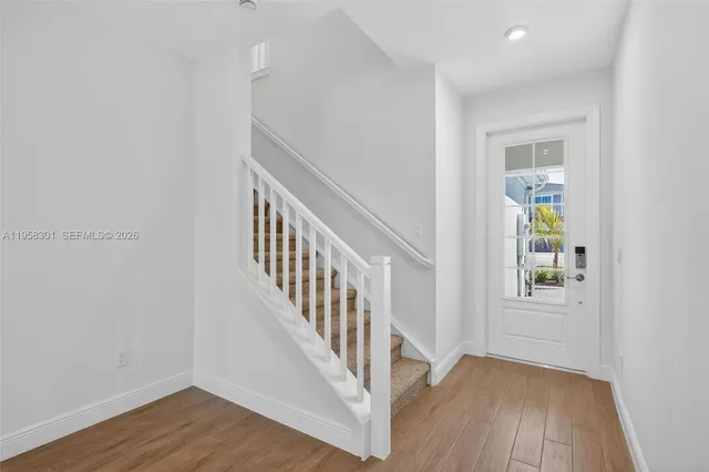 a view of an entryway with wooden floor