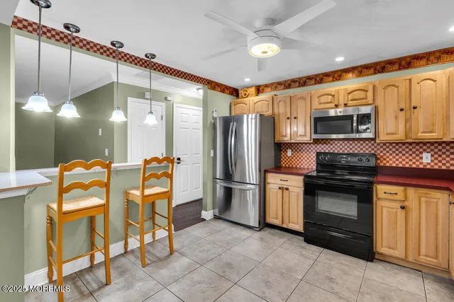 a kitchen with stainless steel appliances granite countertop a refrigerator and a stove top oven