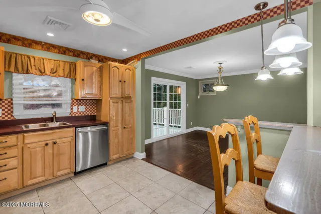 a open kitchen with stainless steel appliances granite countertop a sink and a refrigerator