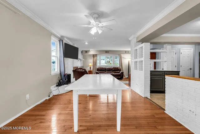 a kitchen view with stainless steel appliances a refrigerator and a wooden floor